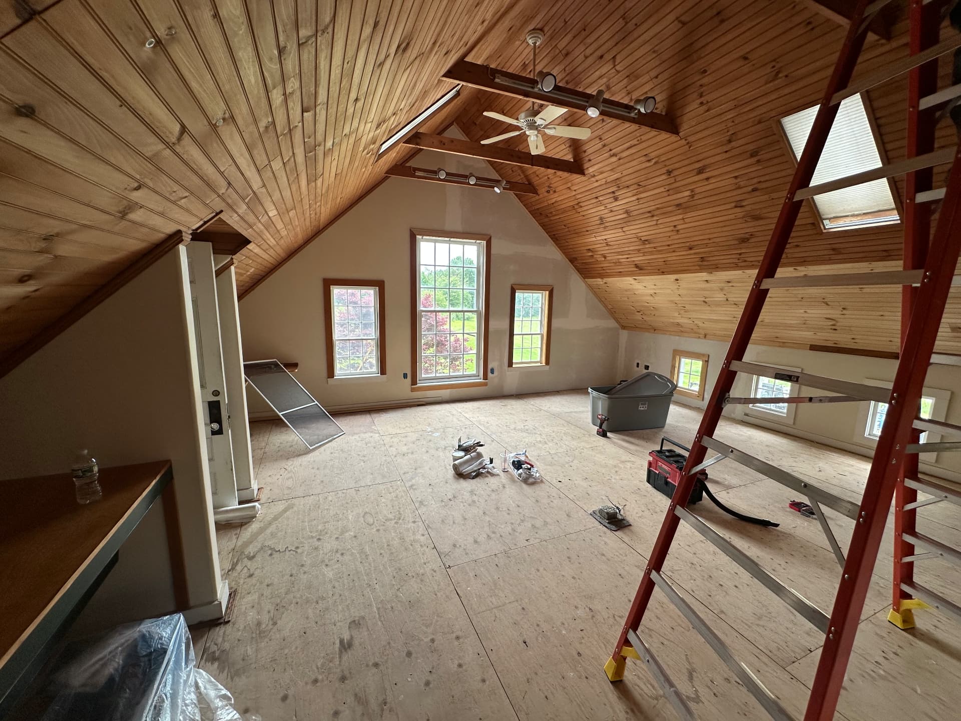 Attic conversion with pine cathedral ceiling, skylights, and exposed beams