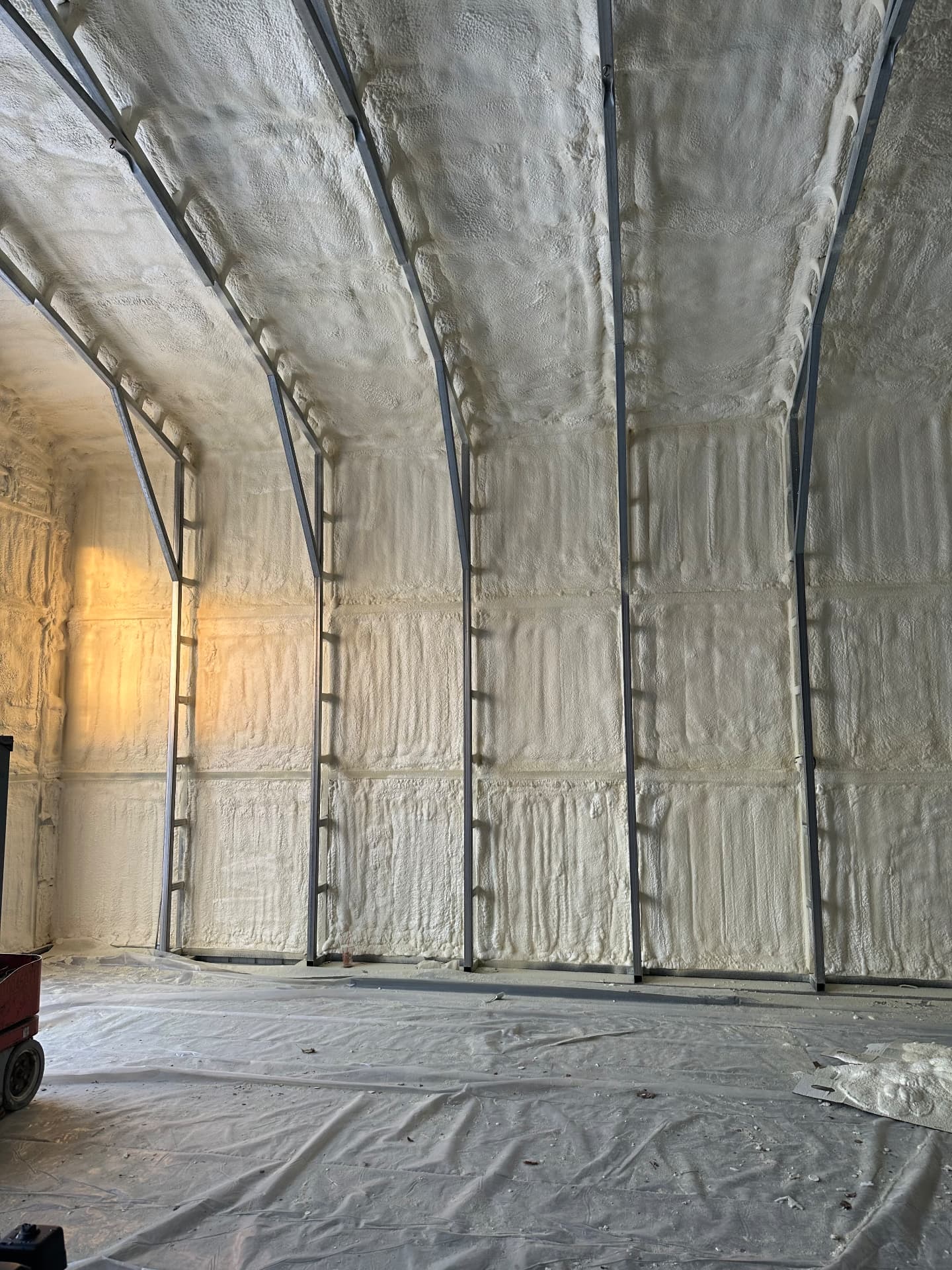 Completed spray foam insulation on steel building walls and roof