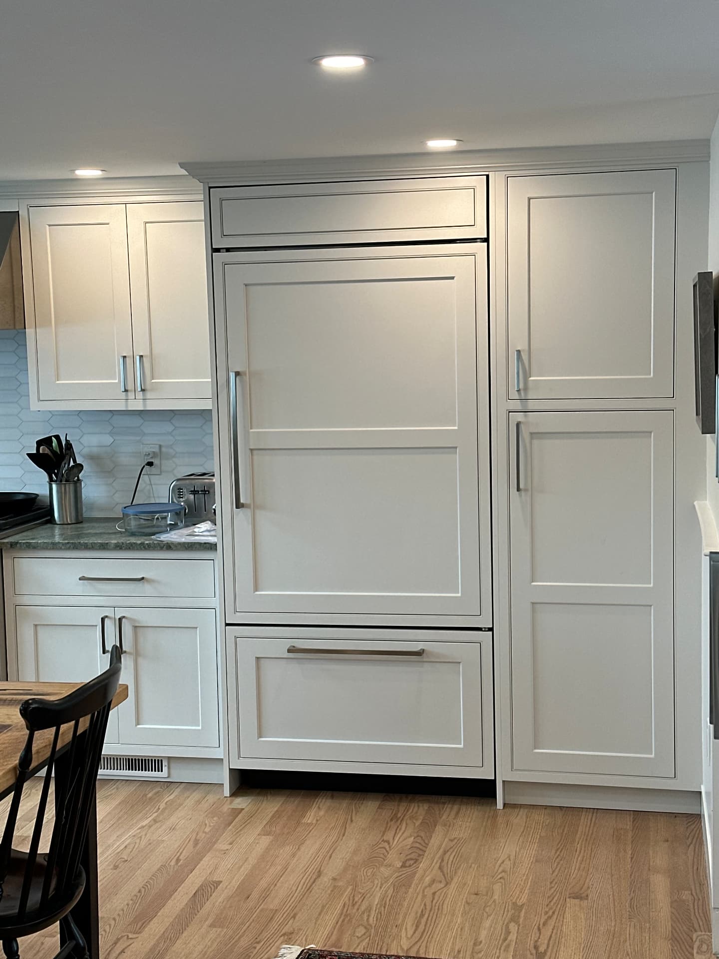 Finished custom kitchen with panel ready refrigerator and inset cabinetry