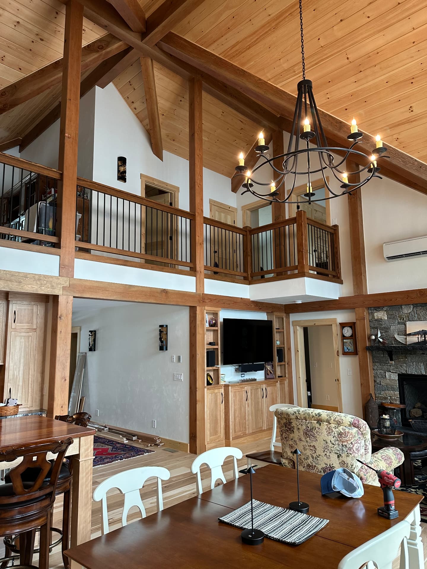 Timber frame great room with loft balcony and cathedral ceiling