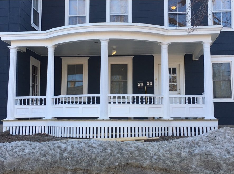 Restored Victorian front porch with turned balusters and fluted columns